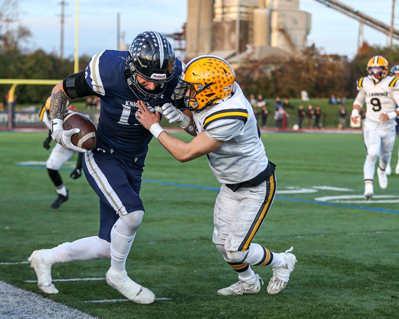 IC Catholic Prep's Eric Karner (19) is tackled out of bounds during Class 4A third round playoff football game between St Laurence at IC Catholic Prep.  Nov 11, 2023.