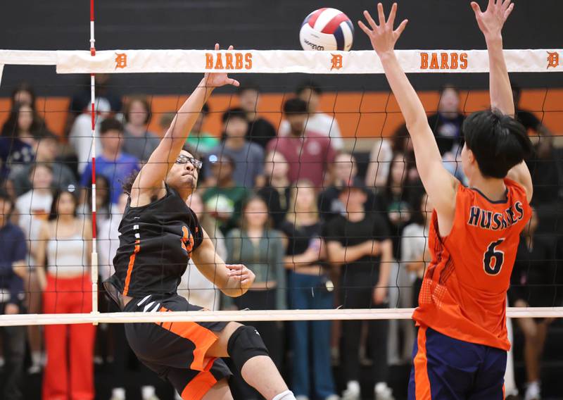DeKalb’s Semaj Cooper spikes the ball Tuesday, April 21, 2026 during their match against Naperville North JV at DeKalb High School.