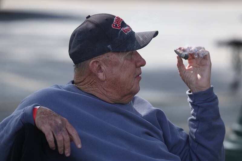 Retired Chicago firefighter Tom Barry enjoys a cigar while listening to the music at the 6th Annual Joliet Blues Festival on Saturday, Aug. 10, 2024 at Bicentennial Park.