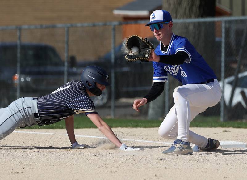 Hiawatha’s Thomas Giebel slides back safely into first as Hinckley-Big Rock's Jacob Orin makes the catch Tuesday, April 29, 2025, during their game at Hiawatha High School in Kirkland.