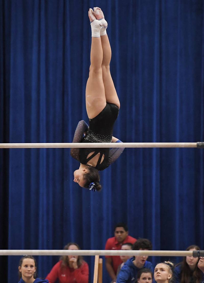 Geneva’s Graci Weems performs on the bars at the Geneva girls gymnastics regional meet in Geneva on Wednesday, February 1, 2023.
