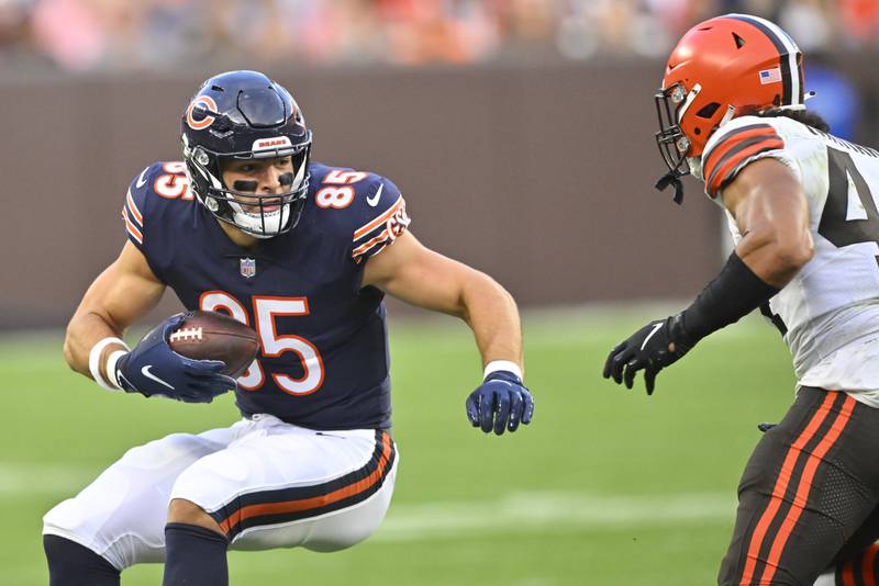 Chicago Bears tight end Cole Kmet tries to evade Cleveland Browns linebacker Sione Takitaki as he runs in the first half, Saturday, Aug. 27, 2022, in Cleveland.