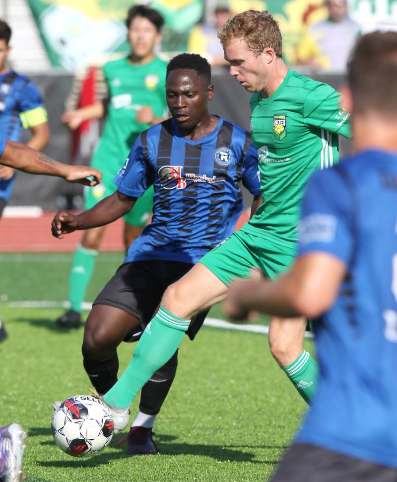 DeKalb County United's Jack Bonavia pushes the ball ahead of a Rockford FC player Saturday, July 29, 2023, at the Soccer & Track and Field Complex at Northern Illinois University in DeKalb.