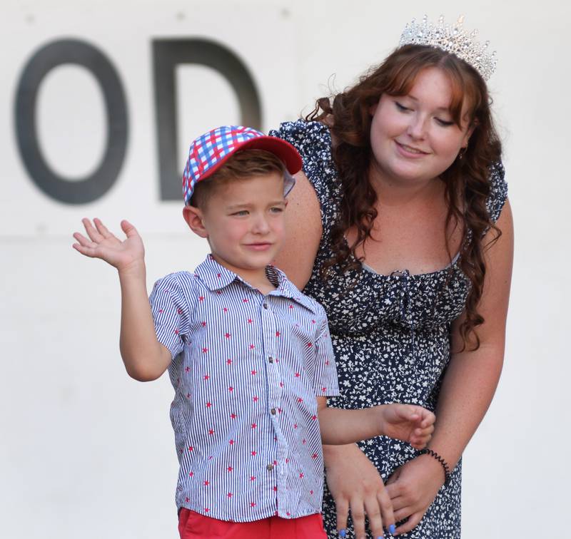 Harrison Taylor, 4, waves to the crowd after being named Let Freedom Ring  Little Mister on Wednesday, July 2, 2025. Pictured with Harrison is Abi Fletcher, the 2024 Let Freedom Ring Queen.