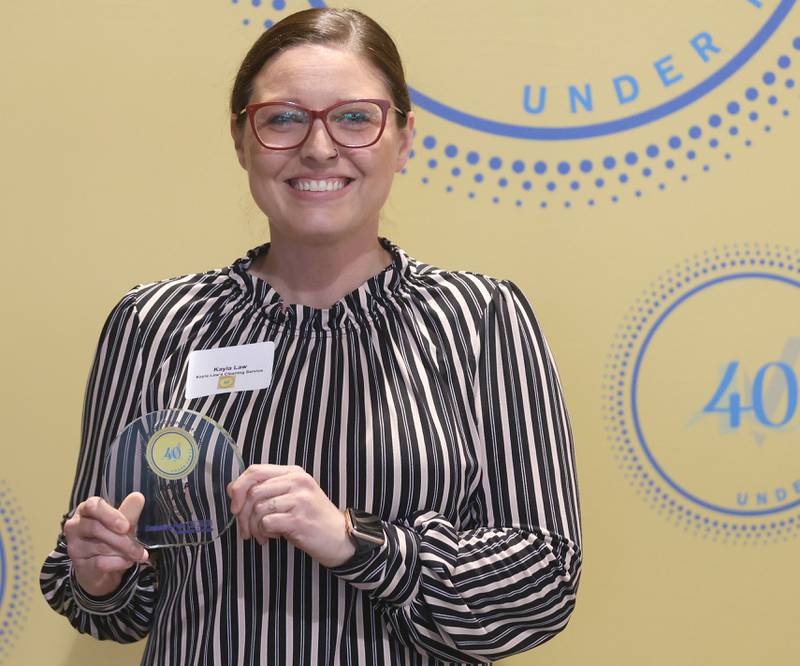 Kayla Law poses with her 40 Under Forty award during the Illinois Valley Chamber of Commerce Champions of Change Awards Night on Wednesday, May 6, 2026 at the Westclox Event Center in Peru.
