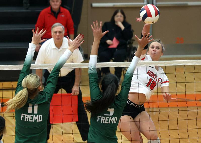 Huntley's Sienna Robertson tries to spike the ball past Fremd’s Natasa Radisic (left) and Akshara Jay Monday, Nov. 11, 2024, during their Class 4A supersectional match at DeKalb High School.