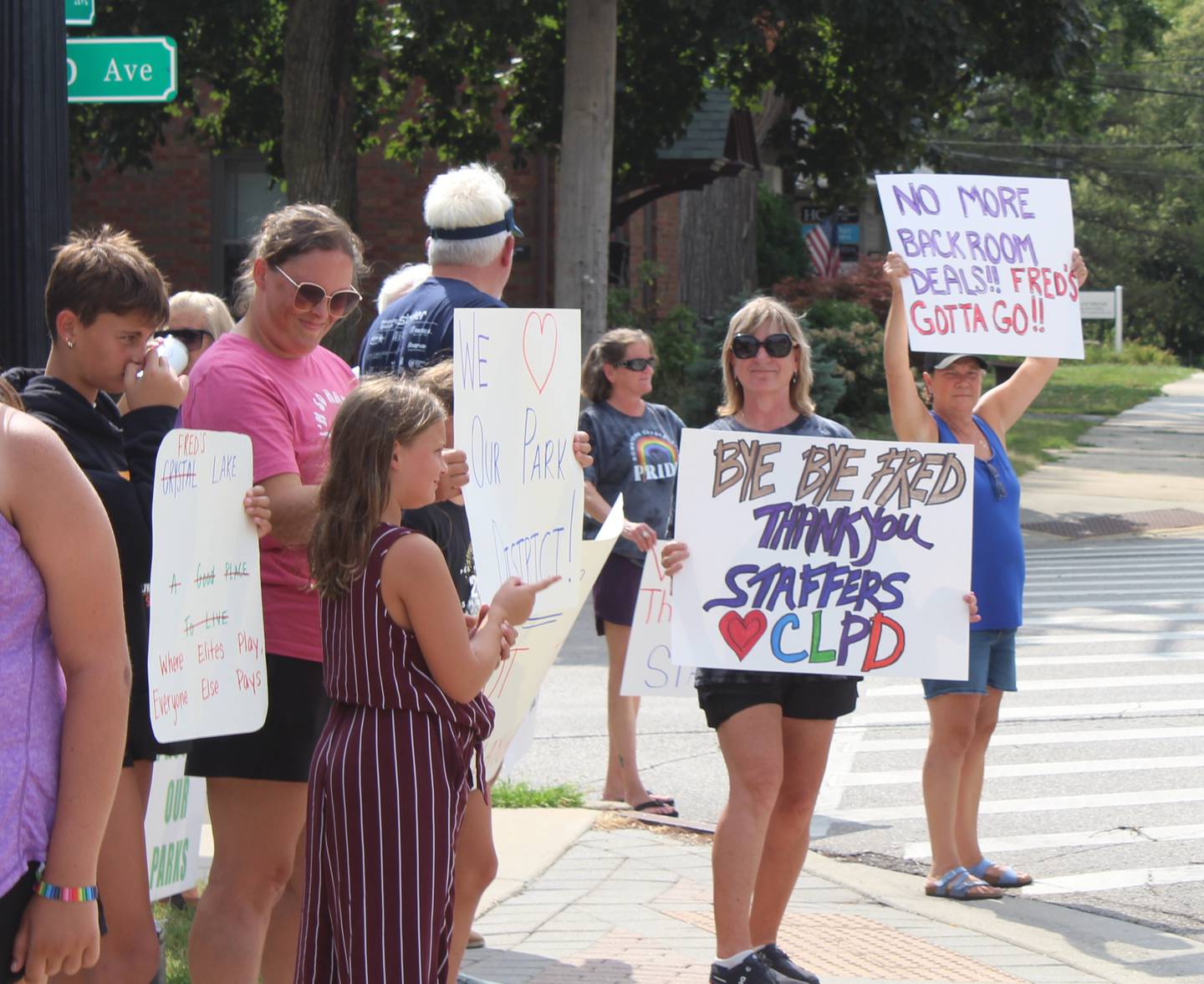About 40 people rallied in support of the Crystal Lake Park District – and against recent actions by the park board – at a rally on Aug. 12, 2025, in front of park district headquarters. Some signs referred to Fred Tiesenga, the newly elected park board president.
