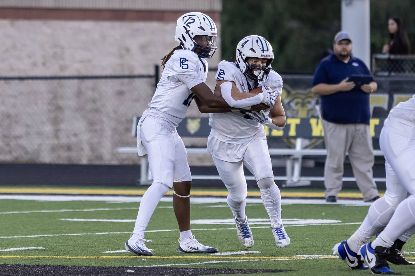 Plainfield South's Jaleel Smith (at left) hands off to Chase Pierceall Friday, Sept. 12, 2025, at Joliet West.