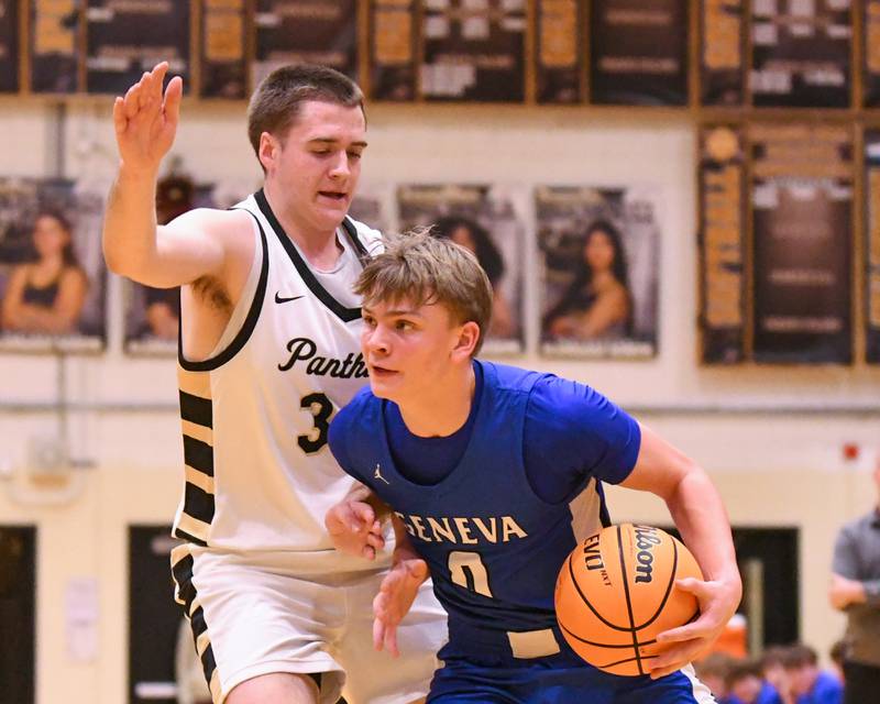 Geneva's Dane Turner (0) drives to the basket while being defended by Glenbard North's Matt Melch (34) during the game on Tuesday Jan. 6, 2026, held at Glenbard North High School.