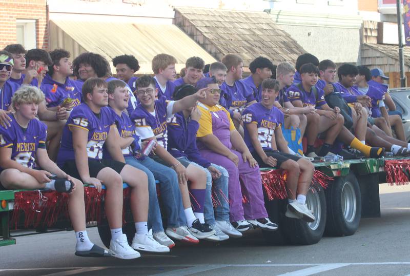 Members of the Mendota High School football team ride down Indiana Avenue during the homecoming parade on Friday, Oct. 3, 2025