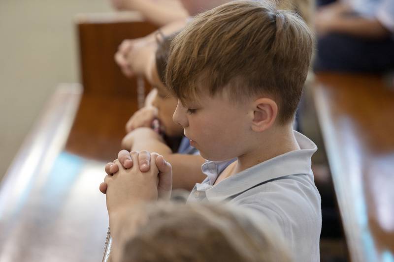 Kaleb Wolf closes his eyes and prays Wednesday, April 23, 2025, at St. Anne’s Church in Dixon. Students, staff and parishioners were invited in to pray the rosary for the recently deceased Pope Francis.
