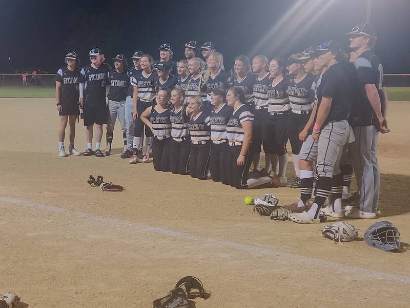 Sycamore baseball and softball players pose for a photo after the softball team's 9-1 win against Kaneland in a Class 3A Belvidere North semifinal in Sycamore. The game started in Belvidere but after a lightning delay moved south under the lights at the Sycamore Park District fields.