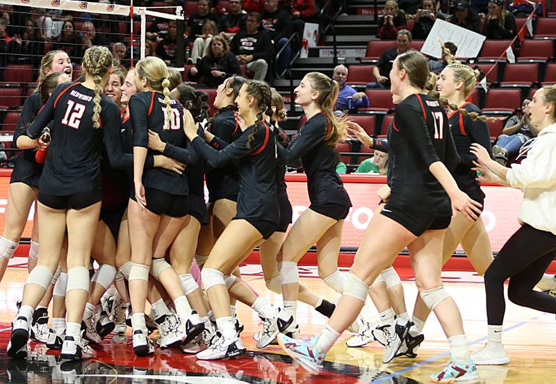 Members of the Benet Academy volleyball run onto the floor as they defeated Barrington in the Class 4A semifinal game on Friday, Nov. 11, 2022 at Redbird Arena in Normal.