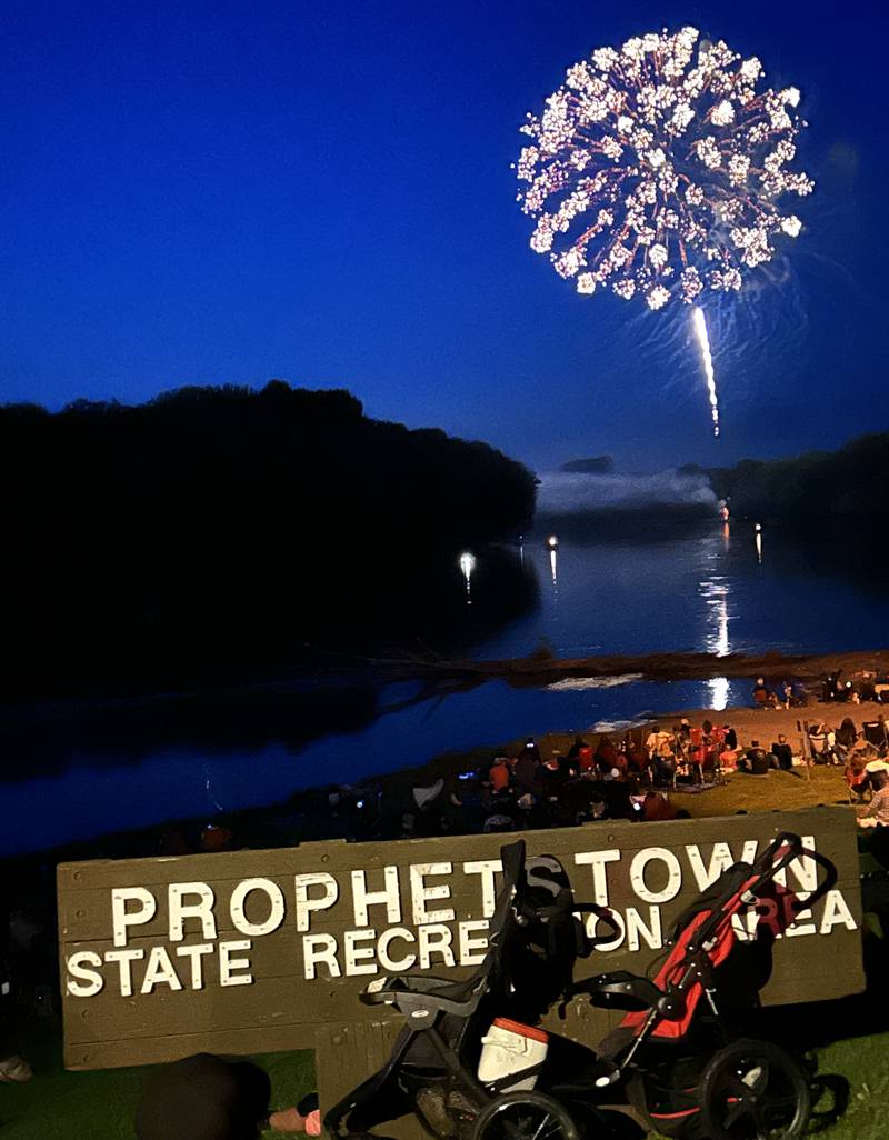 The crowd watches as a firework reflects off the Rock River at Prophetstown State Park on Saturday, July 6, 2024.
