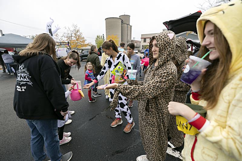 Members of the Sterling High School cross country team hand out candy Wednesday, Oct. 25, 2023 at the Sterling Police department.