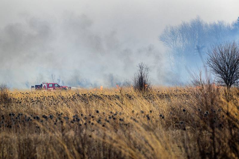 Harmon firefighters respond to a wildfire Friday, March 14, 2025, at Green River State Wildlife Area south of the town. Strong winds made fighting the fire much more difficult and dangerous. Departments from Ohio, Tampico and Wyanet were also seen fighting the blaze. Though the area is sparsely populated, some local residents were evacuated from the area.