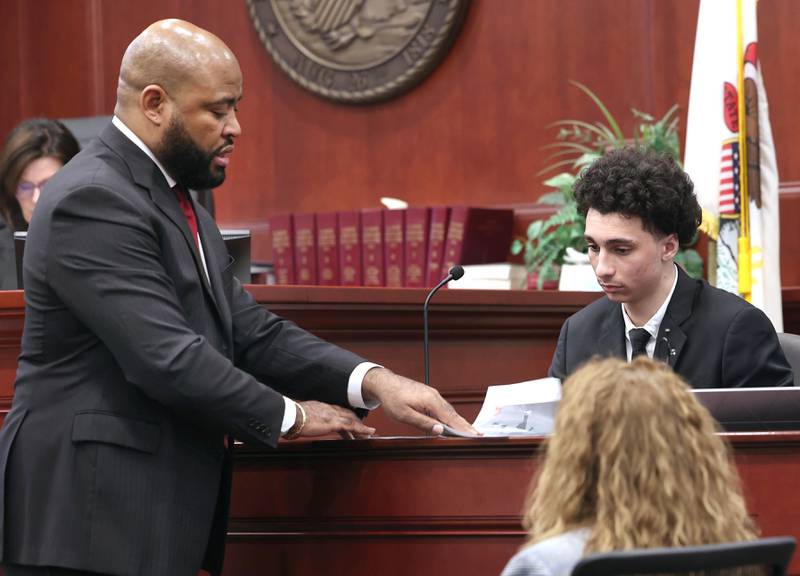 Hamza Khatatbeh, (right) 17, formerly of Sycamore, answers questions from Brandon Brown, one of his lawyers, while taking the stand in his own defense Thursday, Feb. 19, 2026, during the second day of his murder trial at the DeKalb County Courthouse in Sycamore. Khatatbeh is accused of fatally stabbing Sycamore 17-year-old Kaleb McCall in 2023.