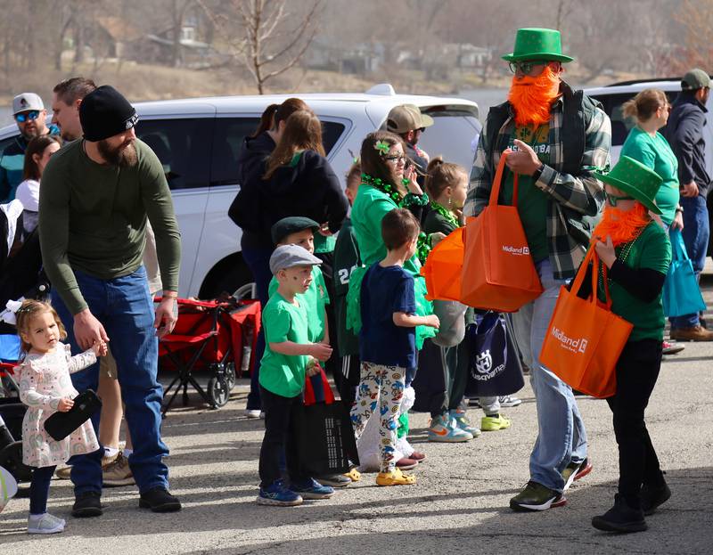 Leprechauns pass out candy during the St. Patrick's Day Parade in Yorkville on Saturday, March 15, 2024.