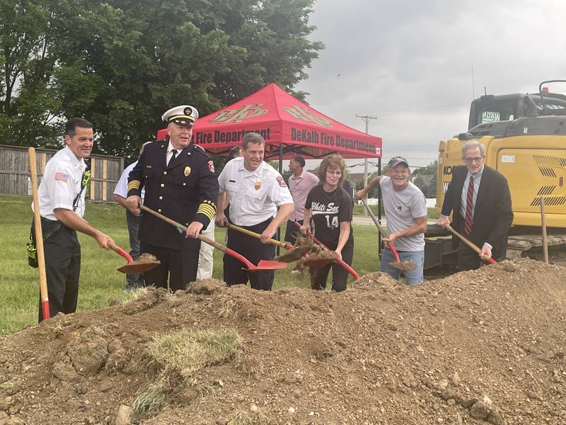 Fire Chief Mike Thomas (second from left) is seen raising a shovel during a groundbreaking ceremony for the city's fourth fire station May 24, 2024 at 1130 S. Malta Road, DeKalb.