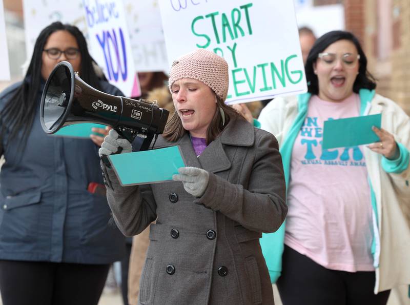 Kelsey Gettle, legal program manager at Safe Passage, leads the chants as the group marches down Locust Street Monday, April 7, 2025, during the Safe Passage Take Back the Night and Survivor Speak Out in Dekalb. The event is held in conjunction with Sexual Assault Awareness Month.
