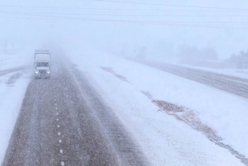 A semi truck travels through heavy snow on Interstate 39 northbound on Tuesday, Jan. 9, 2024 near Oglesby.