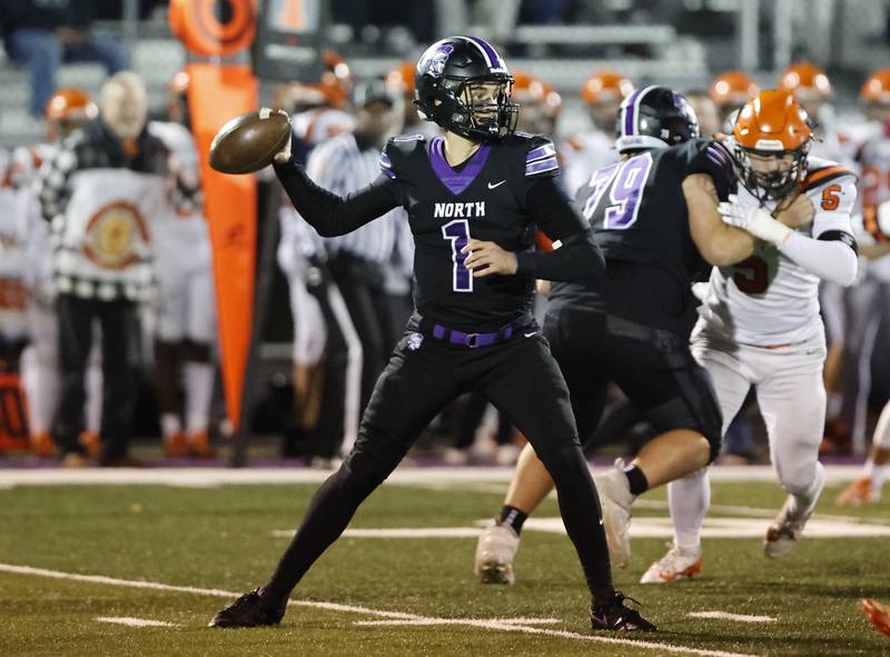 Downers Grove North's Owen Lansu (1) looks to pass during the 7A first-round playoff game between Wheaton Warrenville South and Downers Grove North high schools on Friday, Nov. 1, 2024 in Downers Grove.
