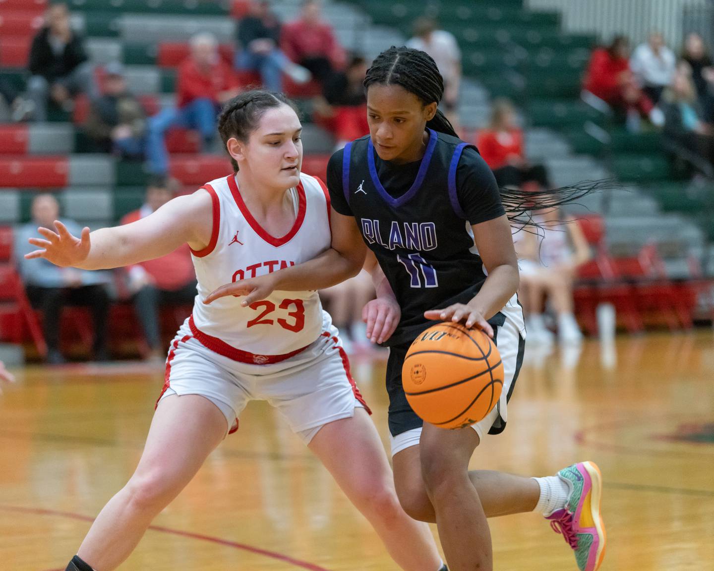 Ottawa's Mary Stisser closely defends Plano's Jaidyn Long during the IHSA Class 3A Girls Basketball Regional semifinal game this past season in Sellett Gym at LaSalle-Peru High School.