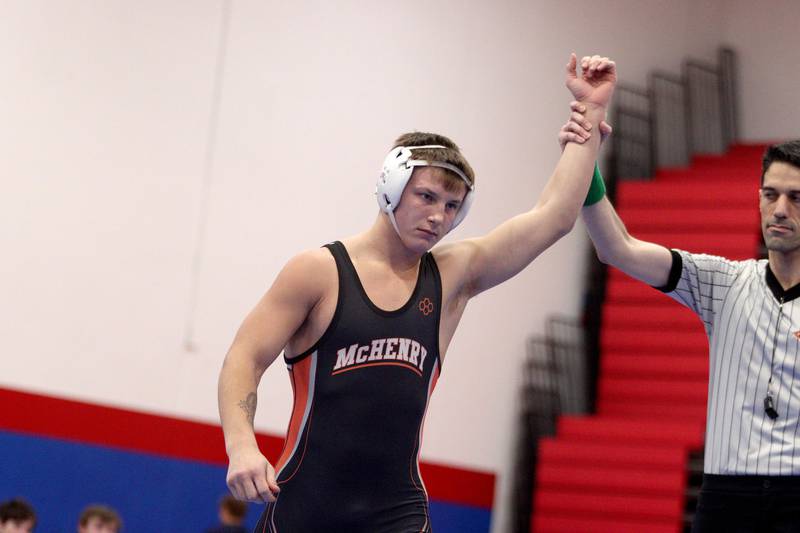 McHenry’s Chris Moore is declared winner at 170 pounds by forfeit in varsity wrestling at Carpentersville Thursday night.