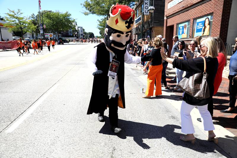 King Charles, the St. Charles East High School mascot, greets onlookers during the school’s homecoming parade on Main Street through Downtown St. Charles on Thursday, Aug. 31, 2023.