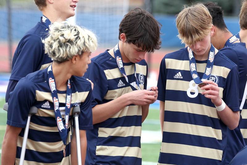 Lemont players check out their 4th place medals Saturday, Nov. 9, 2024, after losing to Prairie Ridge in the Class 2A state third place game at Hoffman Estates High School.