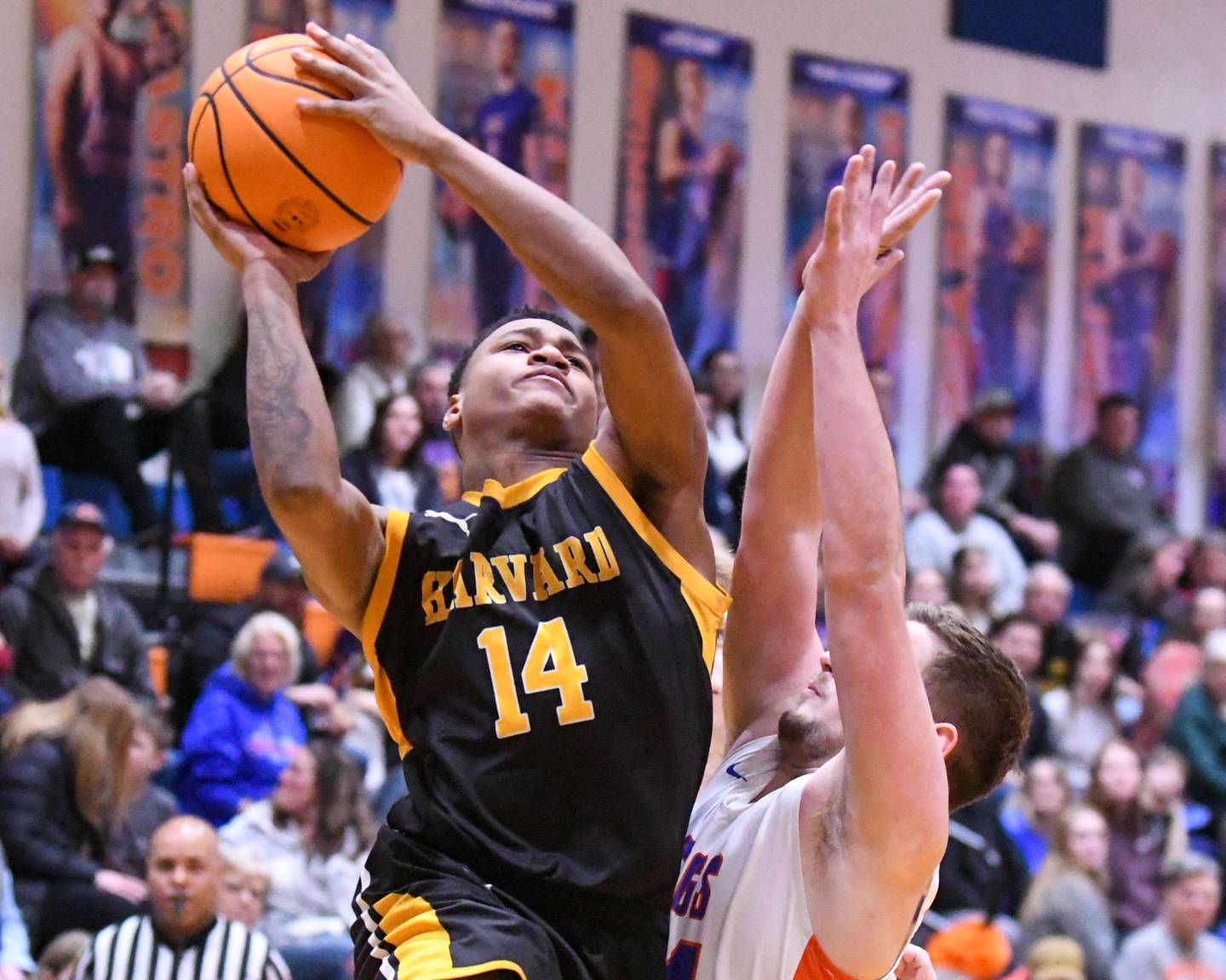 Harvard's DeAndre Keller (14) goes up for a shot while being defended by Genoa-Kingston's Peyton Meyer (24) during the game on Thursday Feb. 13, 2025, held at Genoa-Kingston High School.