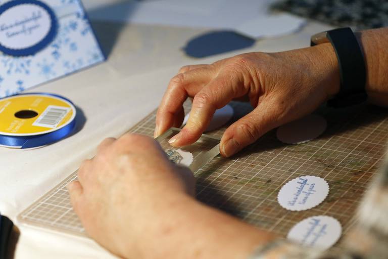 Diane Raycraft, of Crystal Lake, works on creating a handmade Christmas card for senior residents of Hearthstone on Friday, Dec. 10, 2021, in Crystal Lake.  Raycraft makes cards every month for seniors at the residence.