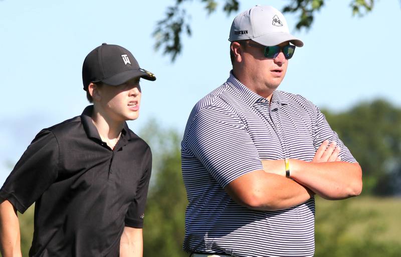 DeKalb's Daniel Rowan Jr. (left) listens to his coach as he waits to tee off on the 4th hole Tuesday, Aug. 9, 2022, during golf practice at River Heights Golf Course in DeKalb.
