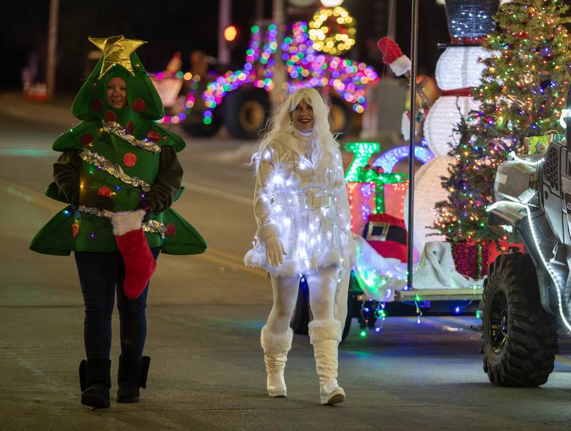 Members from DJ’s Sports Bar & Grill walk alongside the float during the annual Holly Days Frosty & Friends Parade in Westmont on Saturday, December. 7, 2024.