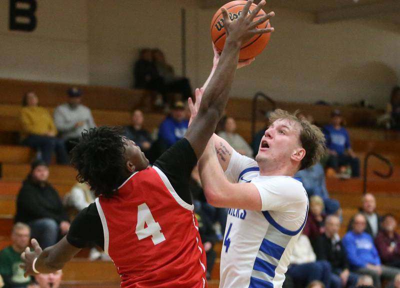 Princeton's Korte Lawson eyes the hoop as Ottawa's Keevon Peterson reaches out to get a piece of the ball on Monday, Feb. 5, 2024 at Prouty Gym.