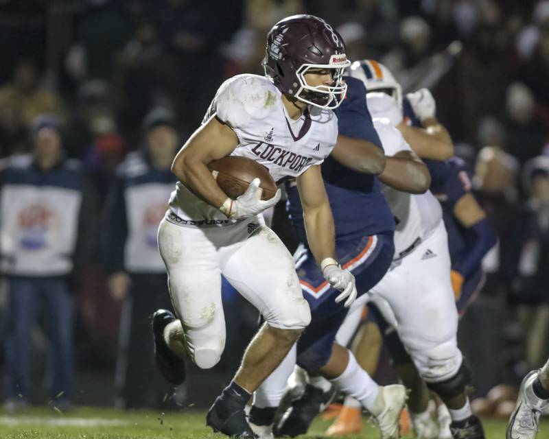 Lockport's Christopher Miller (24) looks for running room during Class 8A semifinal football game between Lockport at Oswego. Saturday, Nov 22, 2025 in Oswego.