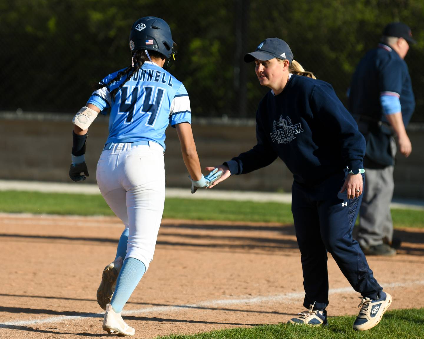 Lake Park's Ariana O'Connell (44) gets congratulated by her coach Lynsey Gunnells after hitting a home run during the game against St. Charles North on Wednesday April 24, 2024, held at Lake Park High School.