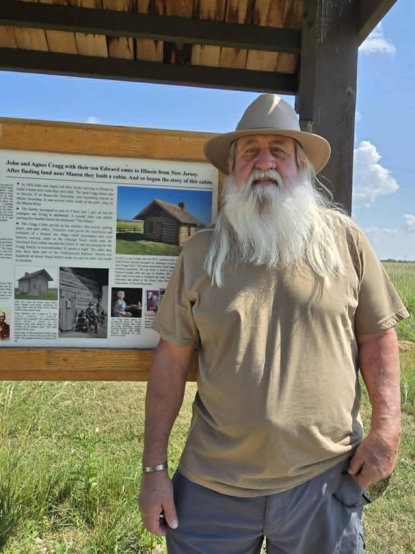 Philip Cragg Burgess stands beside the Kiosk that tells the cabin story.