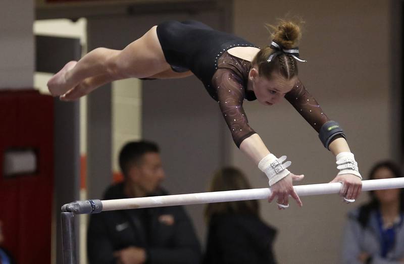 Warrenville South's Jordan Wach competes in the preliminary round of the uneven parallel bars  Friday, Feb. 17, 2023, during the IHSA Girls State Final Gymnastics Meet at Palatine High School.