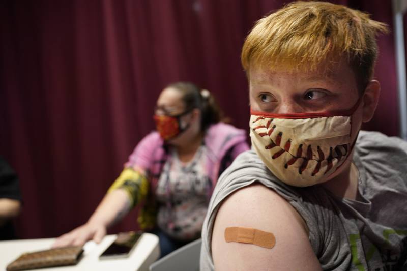 Jacob Conary, 15,  listens to advice from a medical assistant after receiving his first shot of the COVID-19 vaccination, Wednesday, May 12, 2021, in Auburn, Maine. Vaccination clinics in Maine recently opened up to 12 to 15-year-olds. (AP Photo/Robert F. Bukaty)