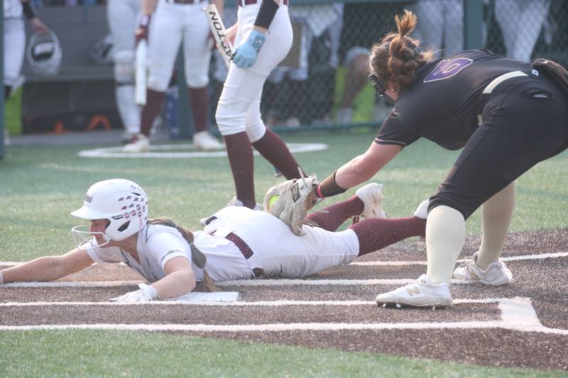LeRoy's Molly Scheyer dives under the tag of Serena pitcher Maddie Glade after throwing a wild pitch during the Class 1A Supersectional game on Monday, June 2, 2025 at Illinois Wesleyan Univesity in Bloomington.