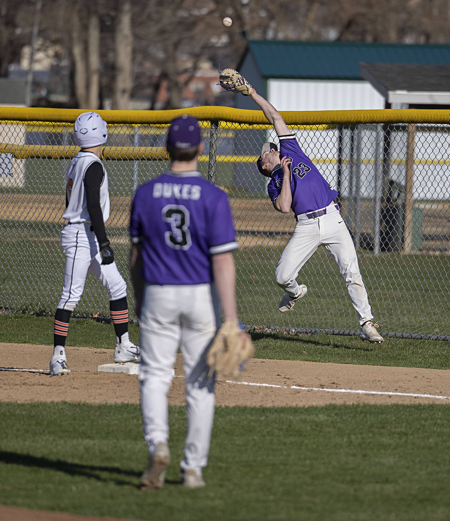 Dixon’s Quentin Seggebruch reaches back to catch a pop fly for an out against Winnebago Thursday, April 6, 2023.