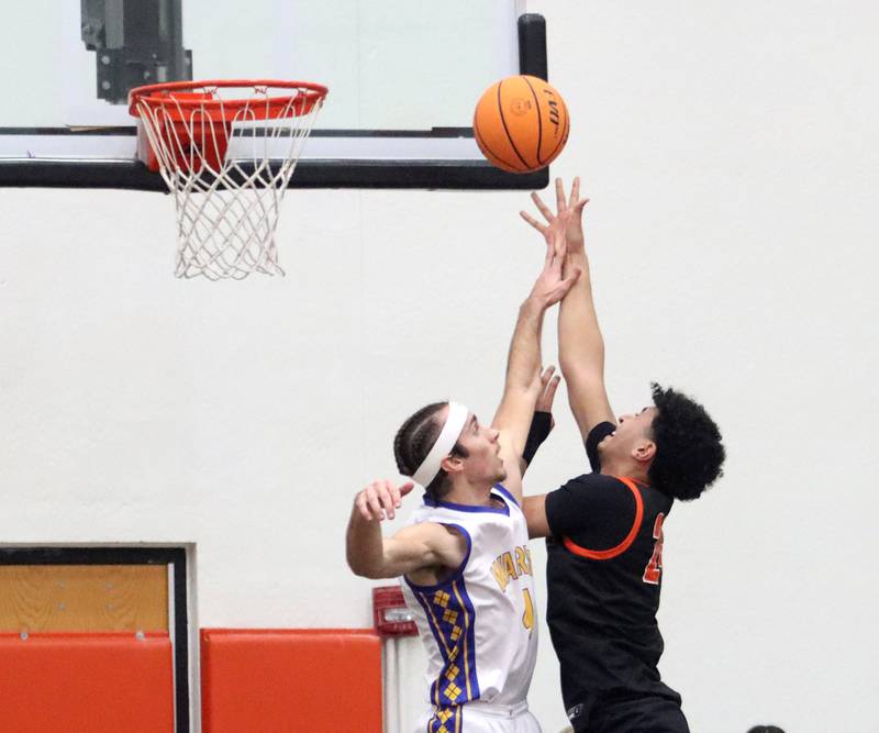 Warren’s Jack Wolf, left, guards McHenry’s Adam Anwar at the net in IHSA Class 4A Regional Title Game boys basketball action on Friday, Feb. 28, 2025 at McHenry High School in McHenry.