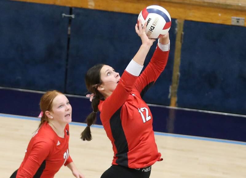 Henry-Senachwine's Kaitlyn Anderson pushes the ball to the Seneca side as teammate Brynna Anderson watches during the Tri-County Conference Championship game on Thursday, Oct. 17, 2024 in Bader Gym at Marquette High School.