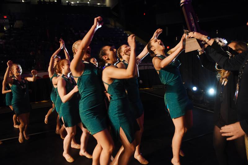 Joe Lewnard/jlewnard@dailyherald.com
Members of the Geneva High School team receive the Class 2A second-place trophy during the Competitive Dance finals at Grossinger Motors Arena in Bloomington Saturday.