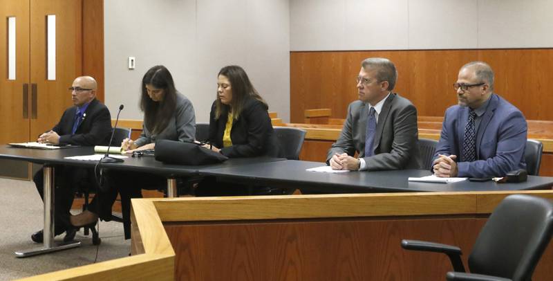 Defendant Carlos Acosta, defense attorney Rebecca Lee, defense attorney Jamie Wombacher, defense attorney Matthew McQuaid, and defendant Andrew Polovin listen to Lake County Judge George Strickland during the fifth day of the trial for the former Illinois Department of Children and Family Services employees Acosta and  Polovin before Lake County Judge George Strickland on Friday, Sept. 15, 2023, at the McHenry County Courthouse. Acosta, 57, of Woodstock, and Polovin, 51, of Island Lake, each are charged with two counts of endangering the life of a child and health of a minor, Class 3 felonies, and one count of reckless conduct, a Class 4 felony, related to their handling of the AJ Freund case.