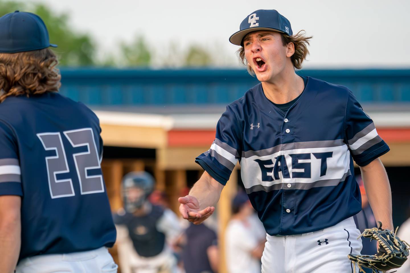 Oswego East's Griffin Sleyko (21) reacts after striking out an Oswego batter to end the inning during a baseball game at Oswego High School on Tuesday, May 9, 2023.