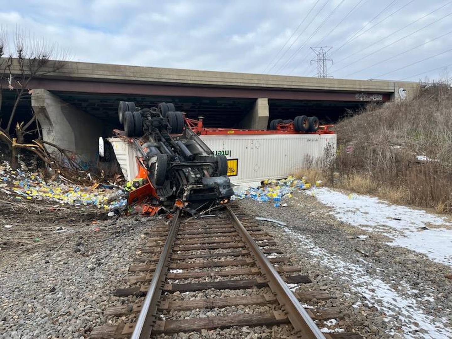 On Sunday morning, a semi driving carrying chicken broth and disinfectant wipes and driving northbound on Interstate 55 near Route 30 rolled off Interstate 55 and onto the train tracks below Interstate 55.