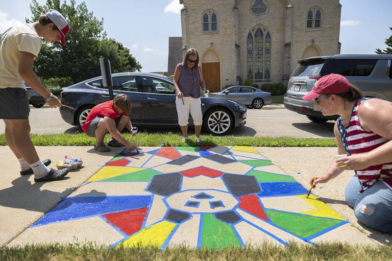Jake (left) and Tyler Zepezauer, Nancy Smoot and Christy Zepezauer work on a collective painting Monday, July 3, 2023 during Petunia Fest’s Brush and Bloom event on the Old Lee County Courthouse lawn in Dixon.