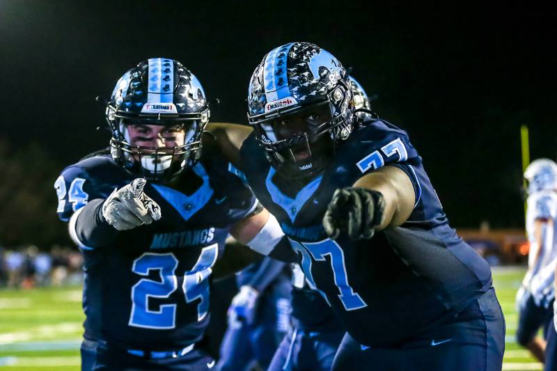 Downers Grove South's Joseph Vieyra (24) celebrates his late touchdown with Jacobi Spraggins (77) during Class 8A Playoff football game between Plainfield South at Downers Grove South on Friday, Nov 1, 2024  in Downers Grove.